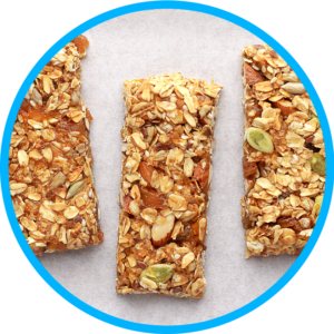 Top view of three nutrition bars with oats, almonds and seeds.